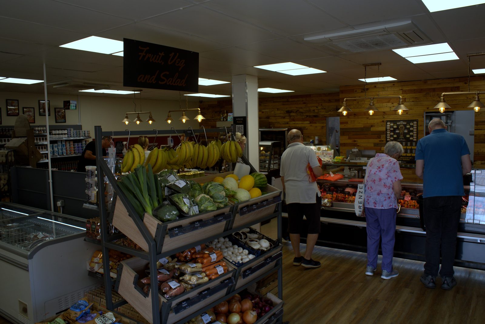 Fruit, veg and salad aisle with customers